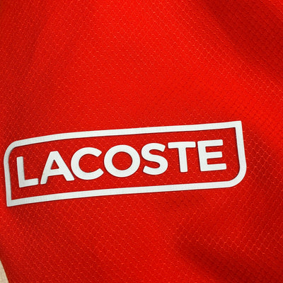orange Lacoste windbreaker {S}