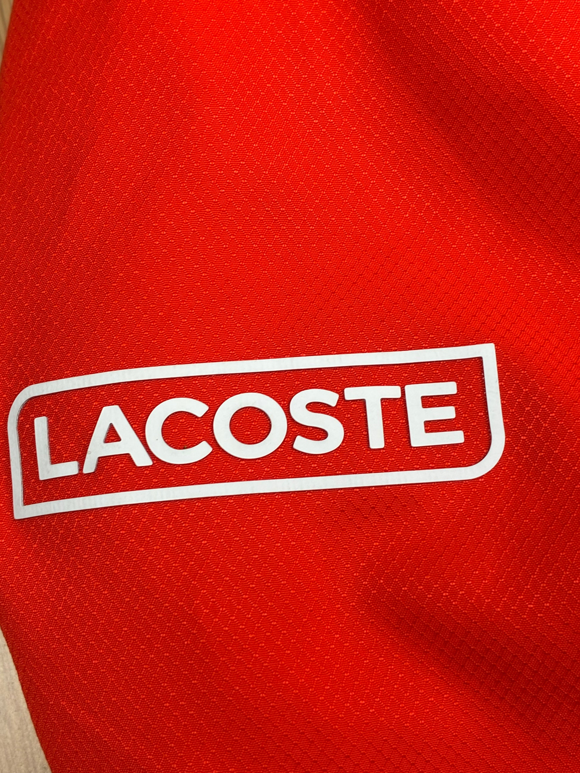 orange Lacoste windbreaker {S}