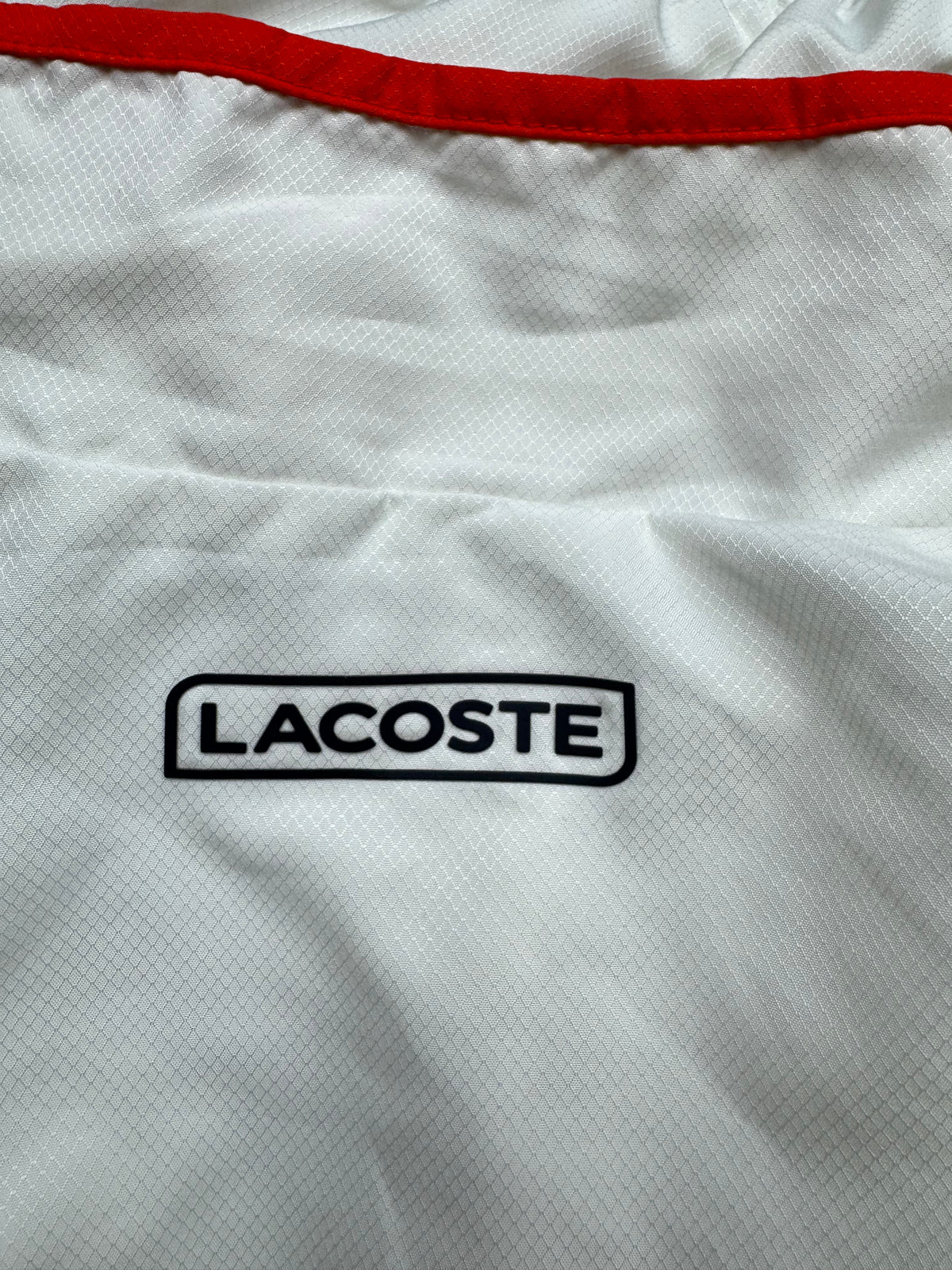 white Lacoste windbreaker {S}