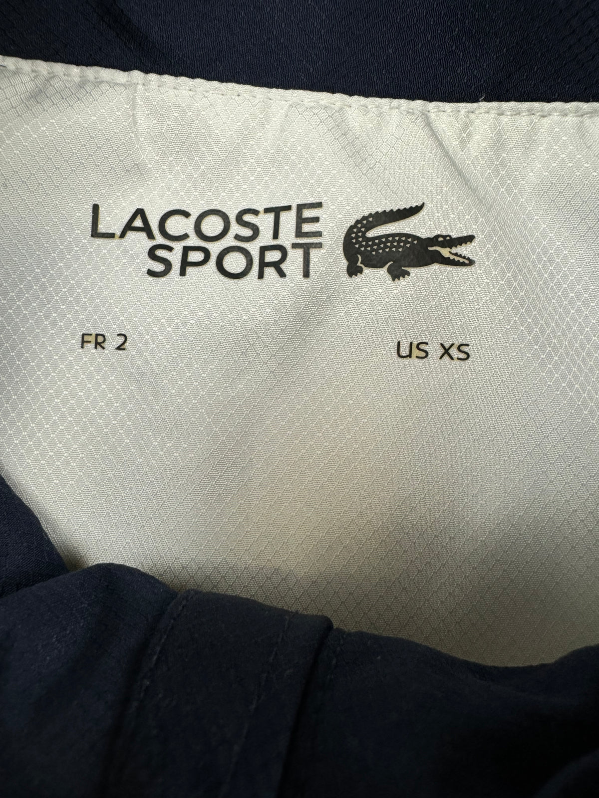 white Lacoste windbreaker {S}