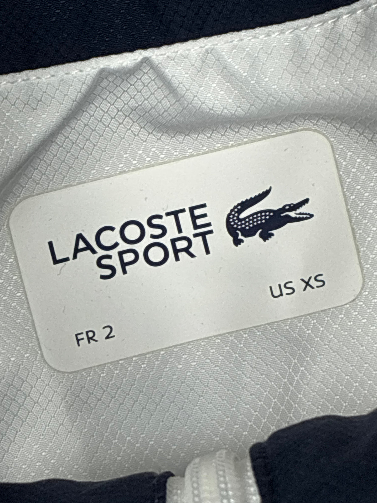 white Lacoste windbreaker {S}