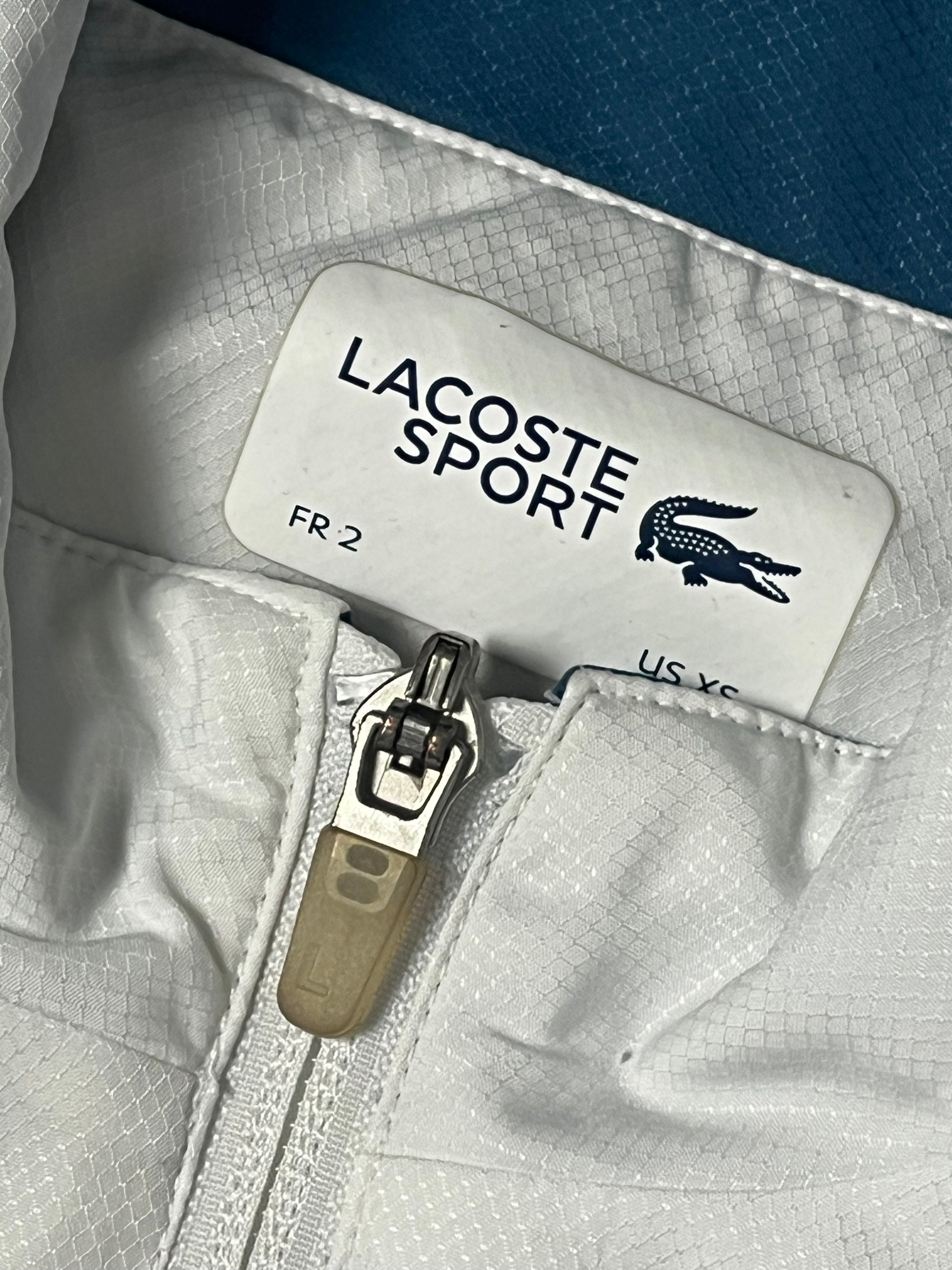 white Lacoste windbreaker {S}