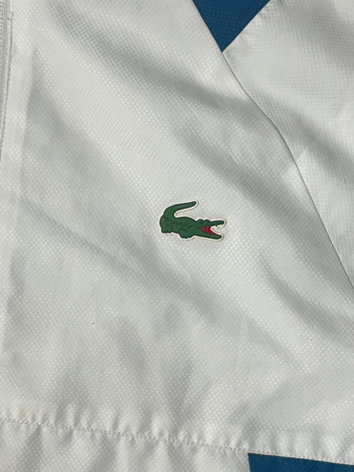white Lacoste windbreaker {S}