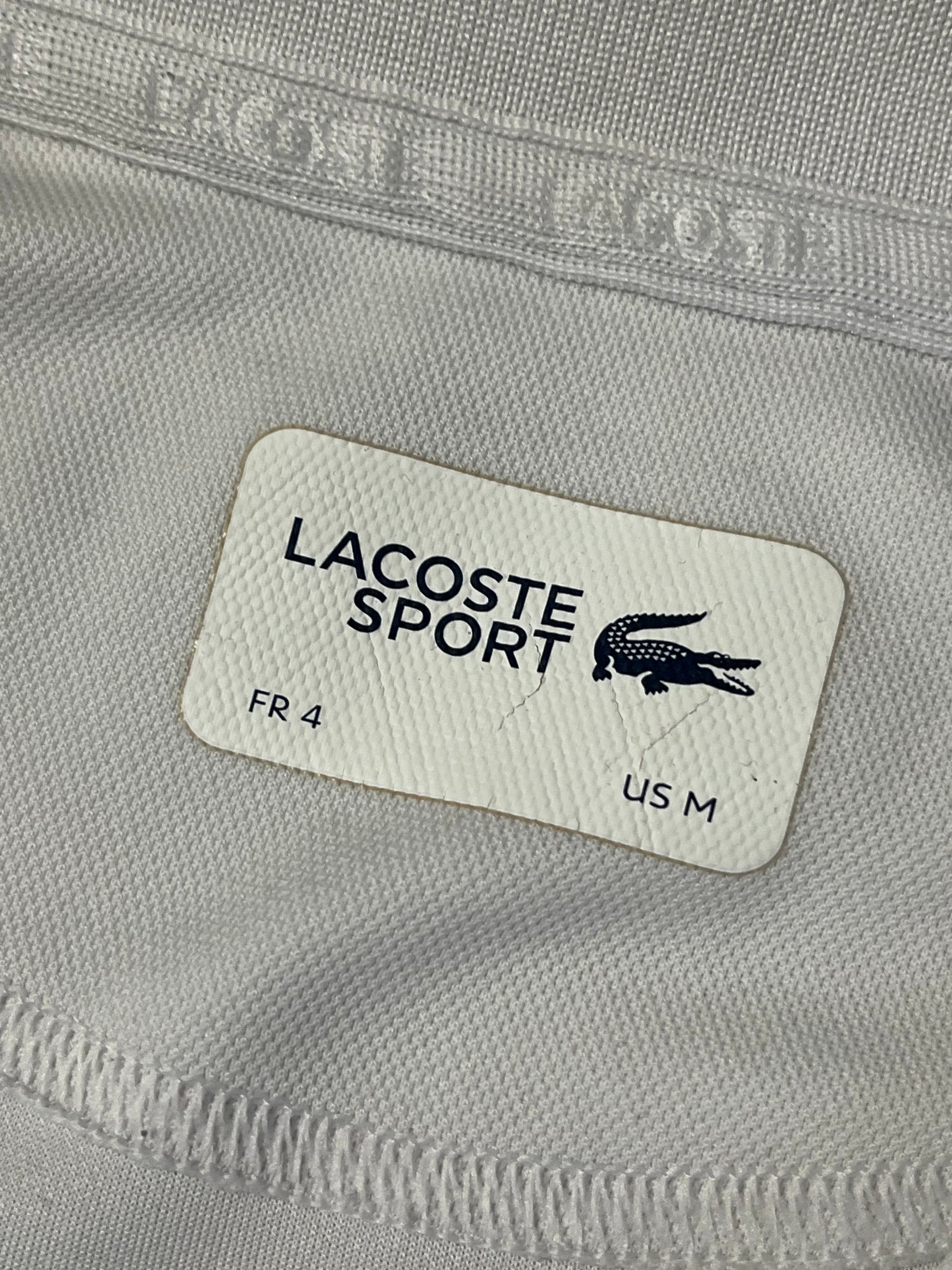 white Lacoste polo {M}