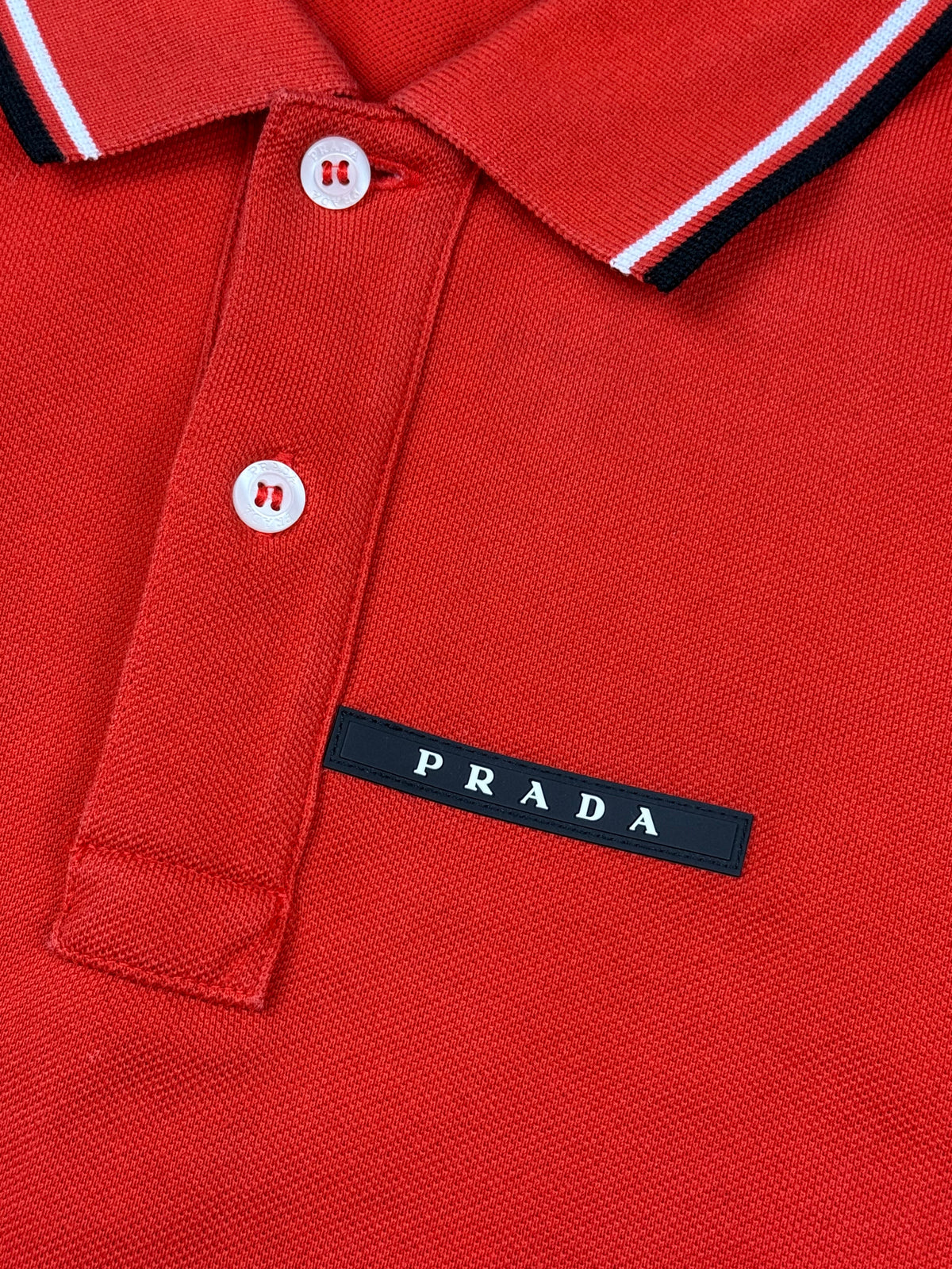 orange Prada polo {M}