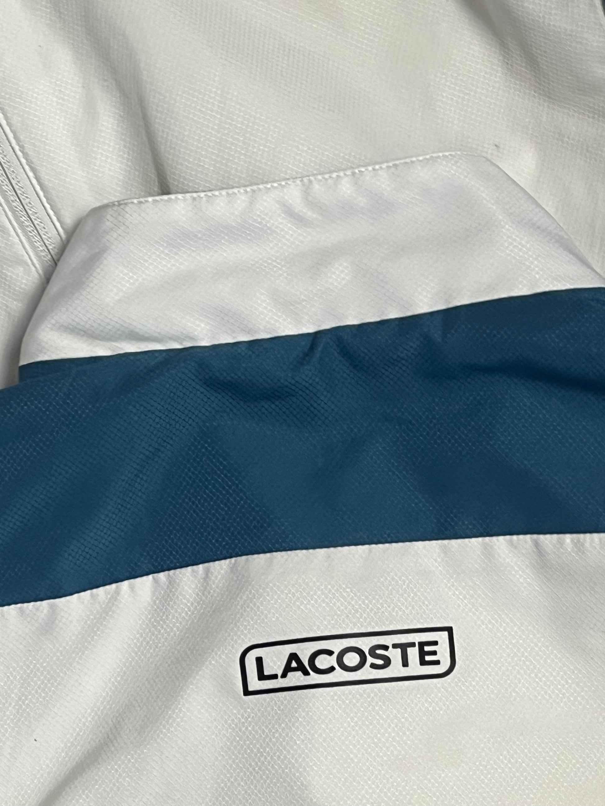 white Lacoste windbreaker {S}